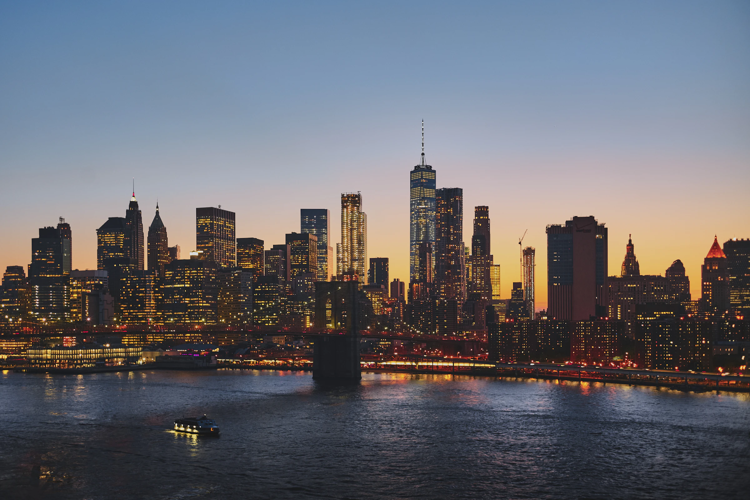 The Brooklyn Bridge and the Manhattan skyline at dusk