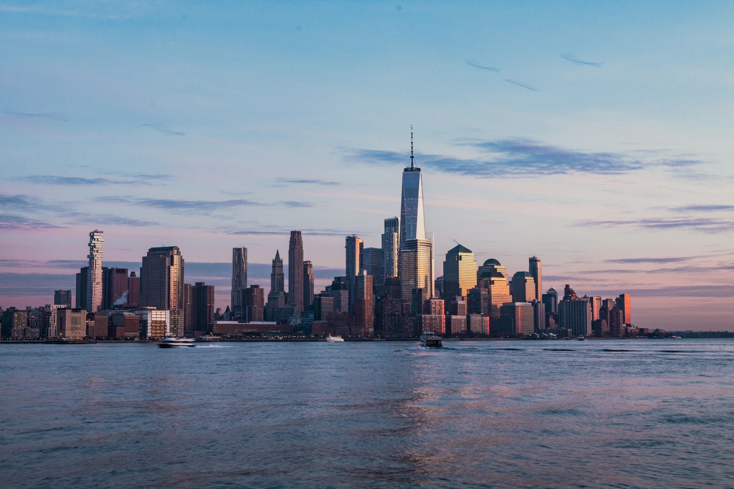 The New York City skyline across the Hudson River from Hoboken at golden hour